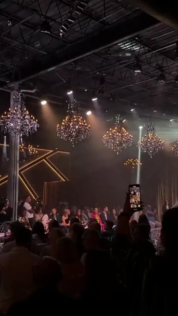 A YFS show night: the audience under chandeliers, young models on the runway, an adult runway walk and the venue red carpet