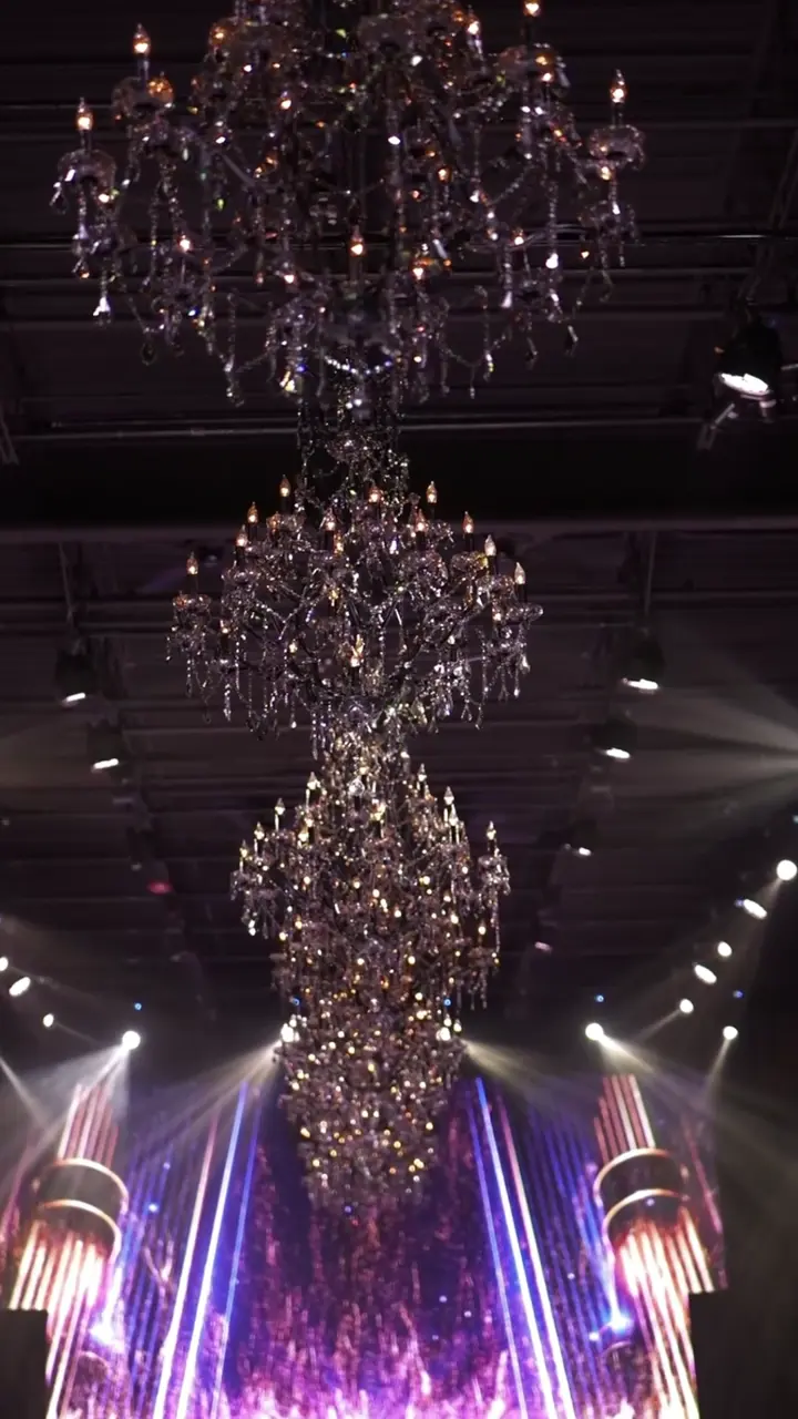 The Chicago stage under chandeliers as participants walk the runway