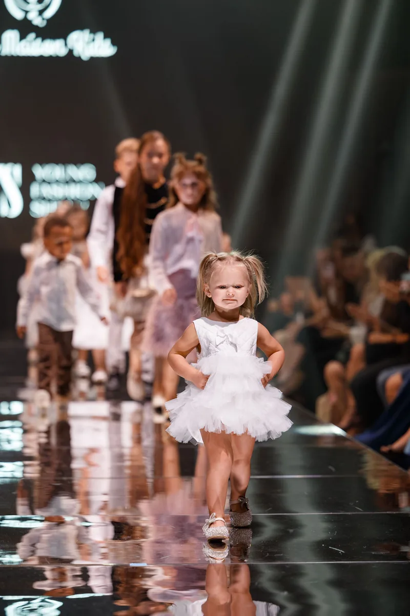 Young children walking the YFS runway together